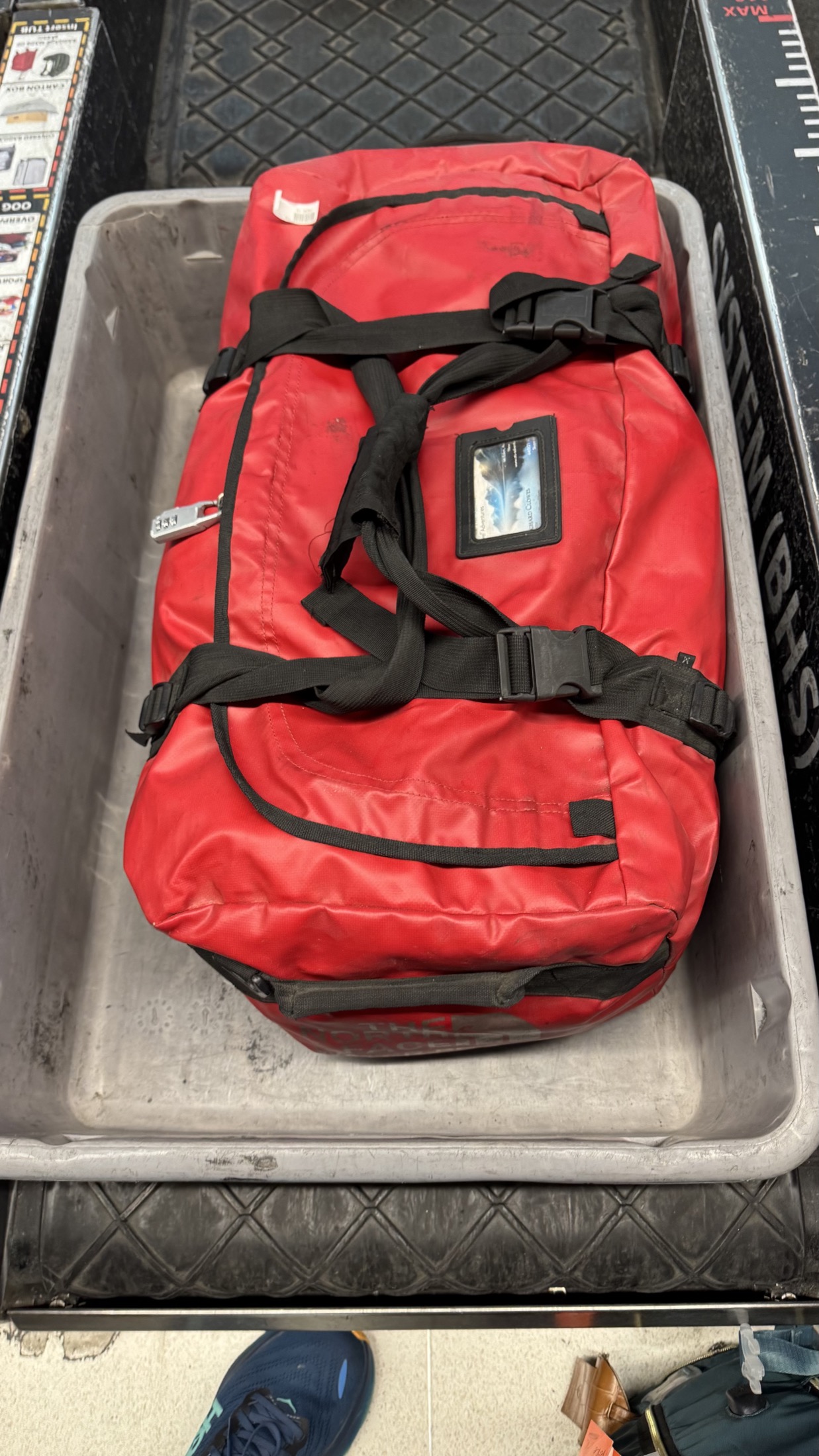 Red duffel bag in checked baggage tray